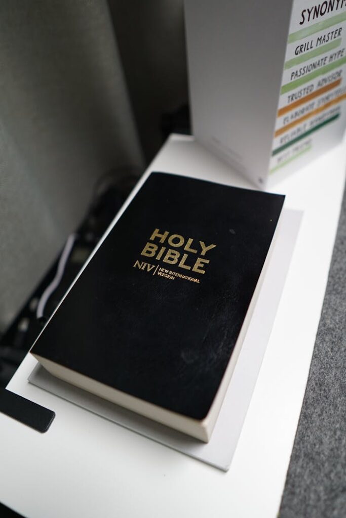 Black Holy Bible on a table, NIV translation, emphasizing religious study.